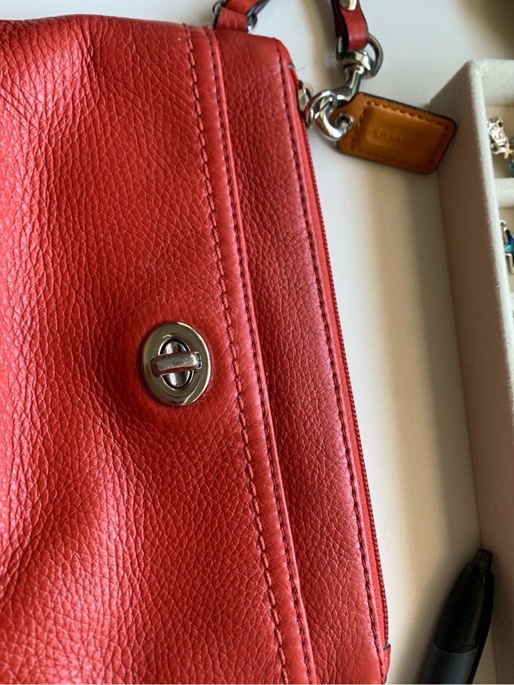 Coach Coral-Red Pebbled Leather wristlet with Silver Turn-Lock
